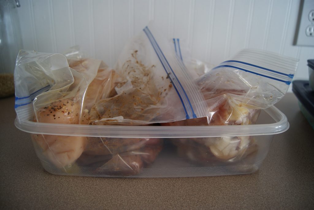 Meals prepped and in plastic bags placed in a plastic container to help with organization.