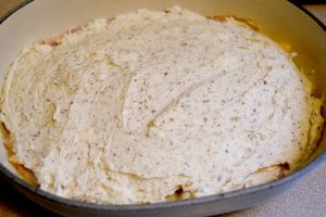 More mixing batter poured on top of the ham and cheese, ready to be heated.