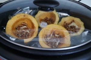 Acorn squash being slow cooked in the crock pot.
