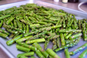 Chopped asparagus on a baking sheet.