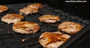 Turkey patties on an open grill.