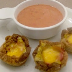 Three ham and cheese cups serve with a cup of soup.