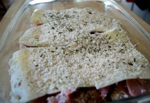 Chicken with cream cheese topped with swiss cheese, ham, and bread crumbs.