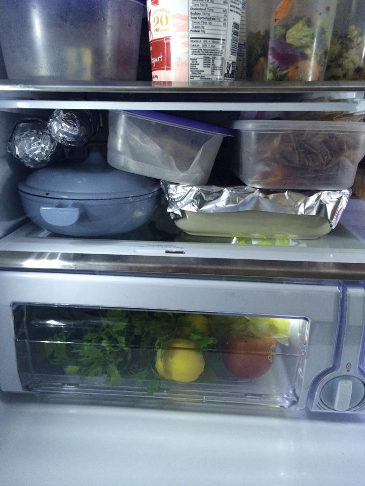 The inside of a refrigerator all organized with meals.