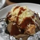 shredded chicken on baked potatoes with bbq sauce