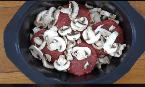 Layered mushrooms and hamburger patties for salisbury steak