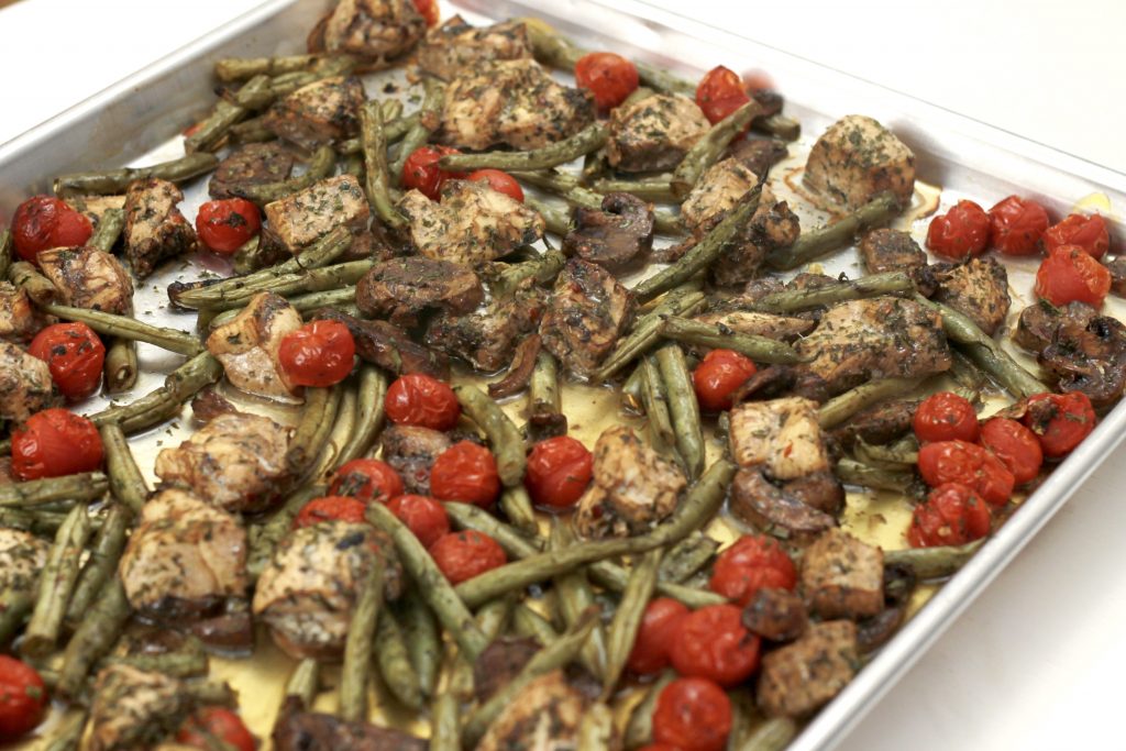 One pan dinner of balsamic chicken, green bean, petite tomatoes ready to be served.