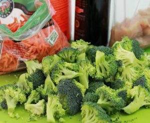 Freshly cut broccoli spears and carrot shoots in a baggie.