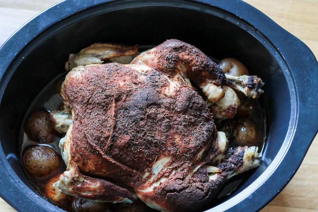Whole roasted chicken in the slow cooker. The family went crazy over this one. Even the picky eaters loved it. The meat just fell off the bones it was so tender. Super simple to make too | 5dinners1hour.com