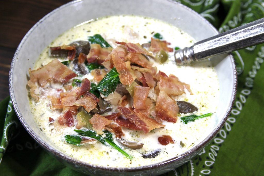 Pic of Keto Instant Pot Chicken Bacon Chowder sitting on a green bandana.