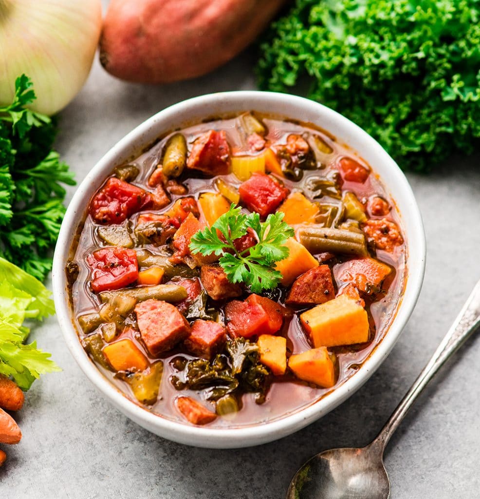 Sausage Kale Soup with sweet potato and green beans in a bowl